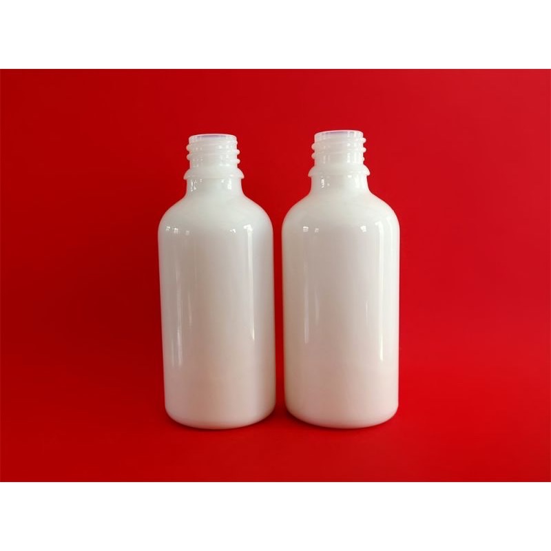 Thumbnail: Two uncapped milky white opal dropper bottles on a red background.