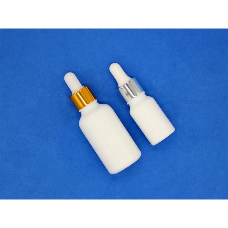 Thumbnail: Two milky white opal dropper bottles with gold and silver collars.