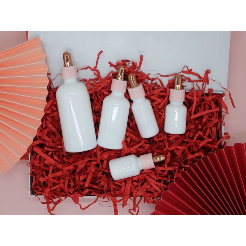 Thumbnail: Milky white opal dropper bottle set in red presentation material.